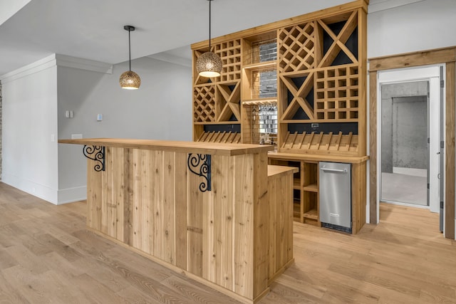 wine cellar featuring crown molding and light hardwood / wood-style flooring