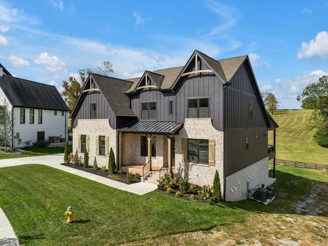 modern farmhouse featuring central AC unit and a front yard