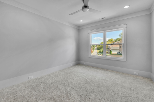 carpeted spare room featuring ceiling fan and ornamental molding