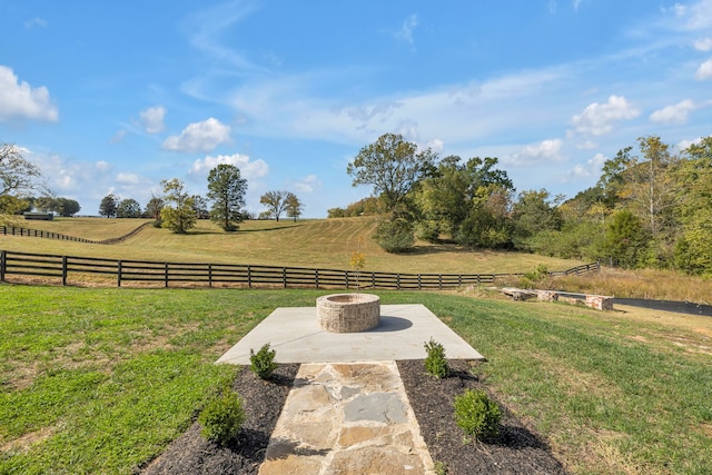 view of yard with a rural view and a fire pit