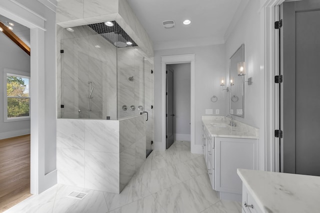 bathroom with vanity, a shower with shower door, and crown molding