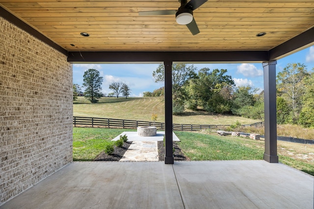 view of patio with ceiling fan and a rural view