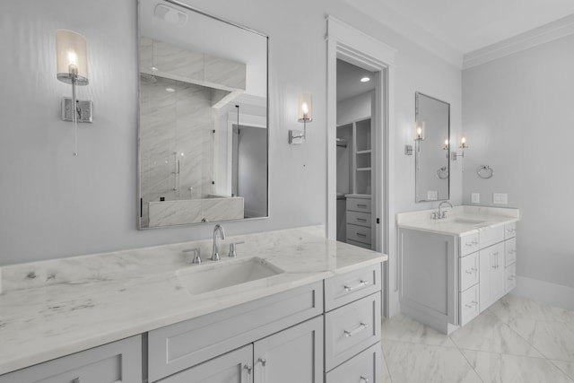 bathroom featuring vanity, a shower with shower door, and ornamental molding