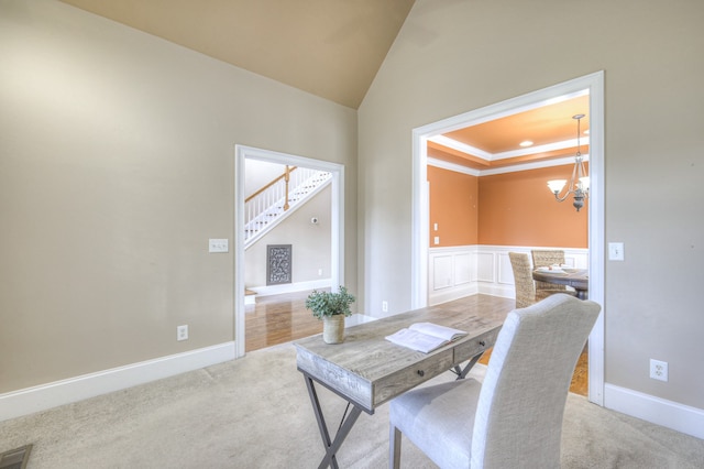 carpeted dining area with a chandelier and ornamental molding