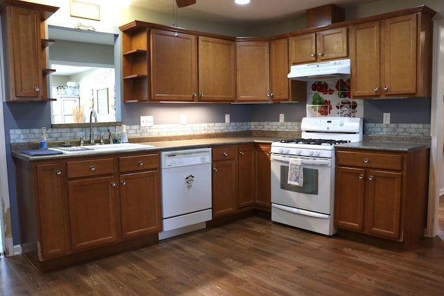 kitchen with white appliances, dark hardwood / wood-style floors, sink, and decorative backsplash