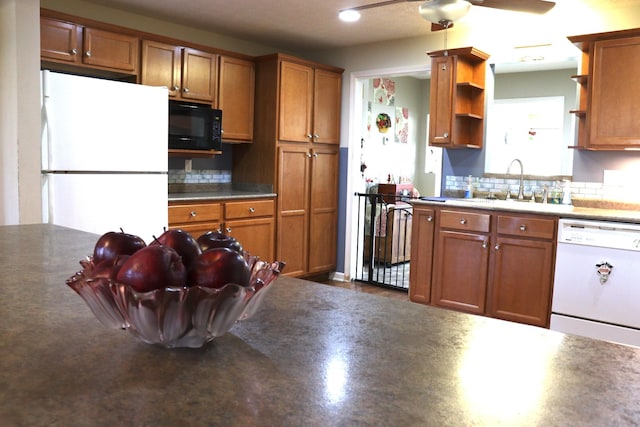 kitchen with ceiling fan, sink, backsplash, and white appliances