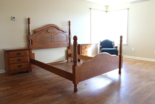 bedroom with hardwood / wood-style flooring