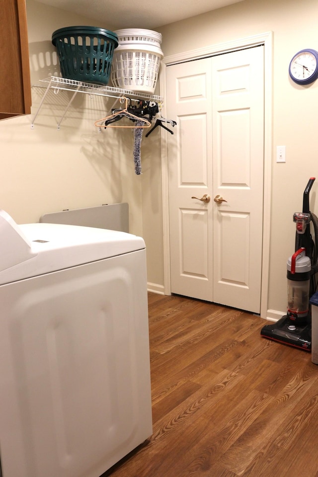 clothes washing area featuring washer / dryer and hardwood / wood-style flooring