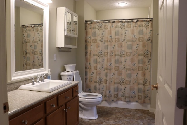 full bathroom featuring vanity, toilet, shower / tub combo, and a textured ceiling