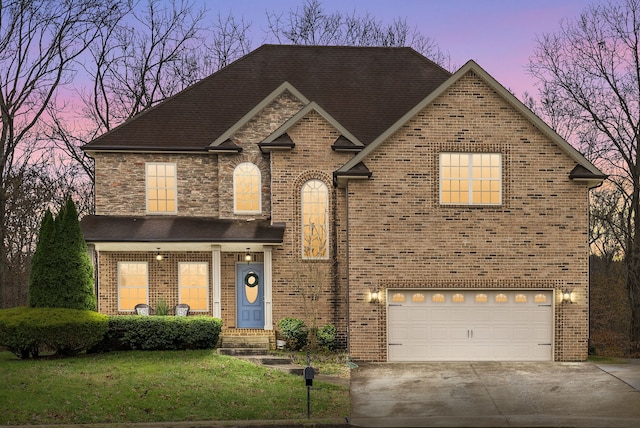 view of front facade with a garage and a lawn