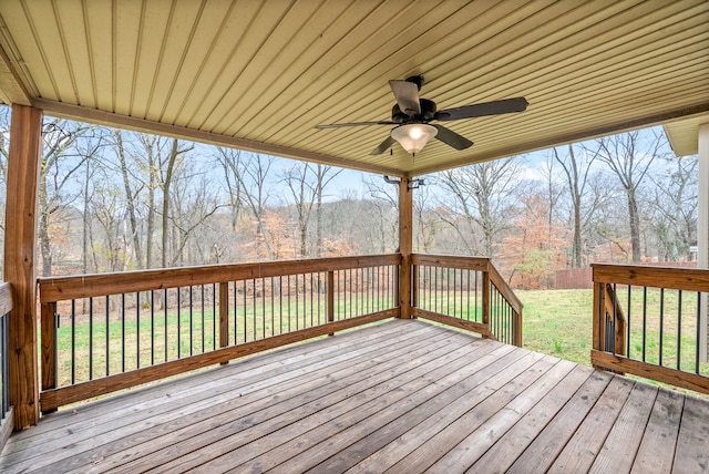 wooden terrace featuring a yard and ceiling fan