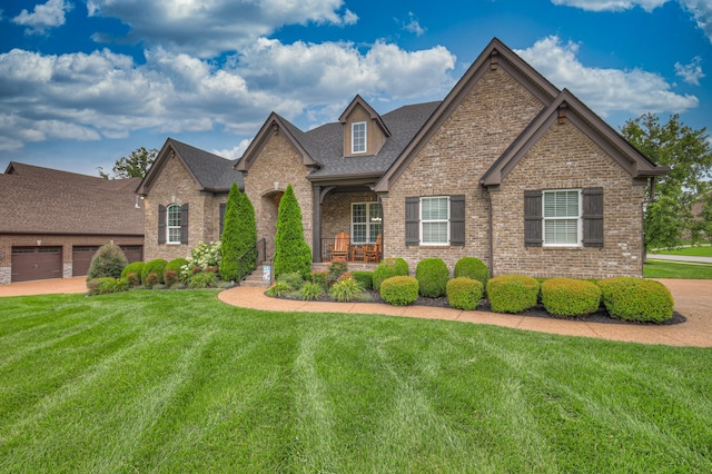 view of front of home with a front lawn, a porch, and a garage