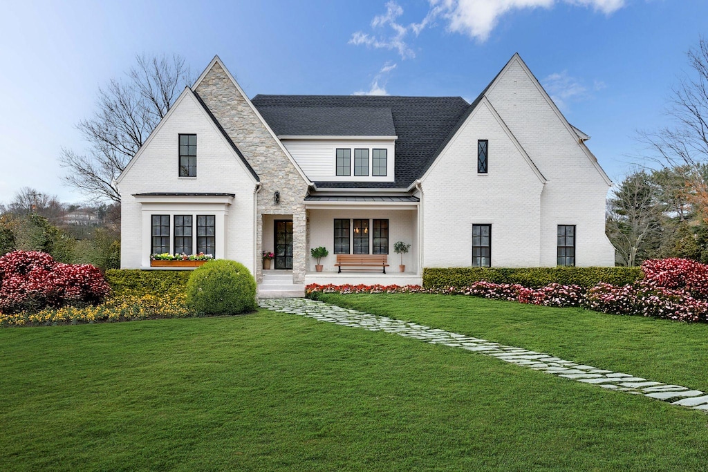 view of front of house with a front yard and covered porch