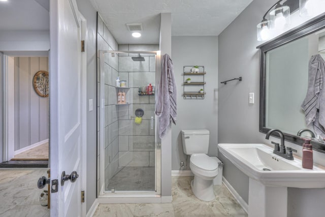 bathroom featuring sink, toilet, and walk in shower