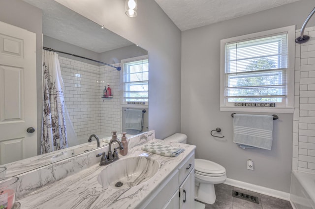 full bathroom featuring tile patterned flooring, vanity, a healthy amount of sunlight, and a textured ceiling