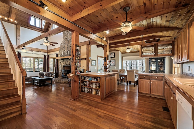 kitchen featuring a wealth of natural light, dark hardwood / wood-style flooring, wooden ceiling, and tile counters