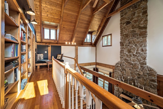 corridor with a healthy amount of sunlight, wood-type flooring, high vaulted ceiling, and wooden ceiling