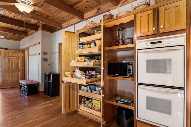 kitchen with beam ceiling, ceiling fan, white double oven, dark hardwood / wood-style flooring, and wood ceiling