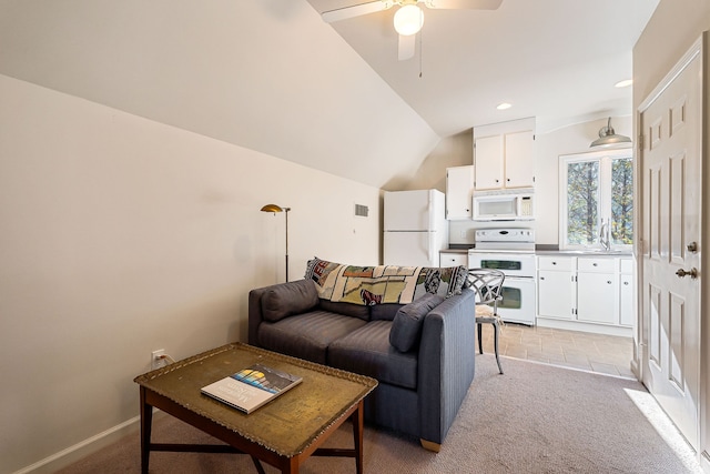 carpeted living room with ceiling fan, sink, and vaulted ceiling