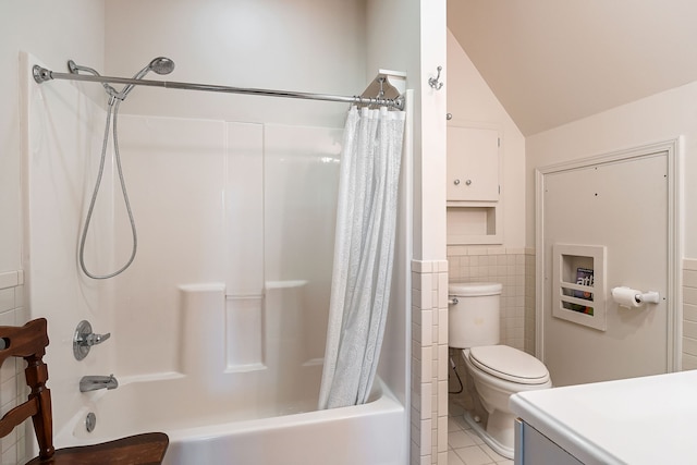 full bathroom with tile patterned floors, vaulted ceiling, shower / tub combo with curtain, tile walls, and toilet