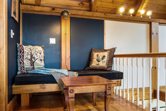 living area featuring hardwood / wood-style floors, beamed ceiling, and wooden ceiling