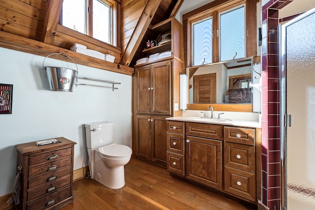 bathroom with an enclosed shower, wooden ceiling, hardwood / wood-style floors, vaulted ceiling with beams, and toilet