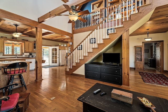 living room featuring wood ceiling, ceiling fan, sink, beam ceiling, and dark hardwood / wood-style floors