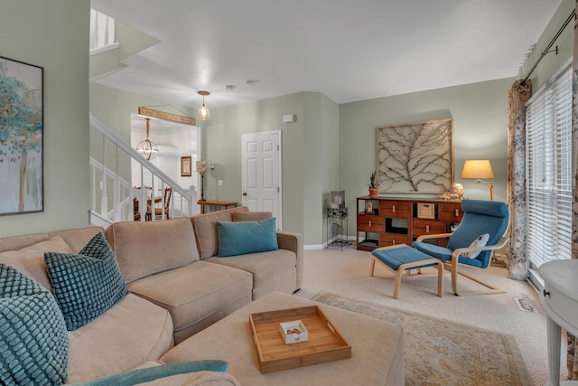 living room with carpet floors and a notable chandelier