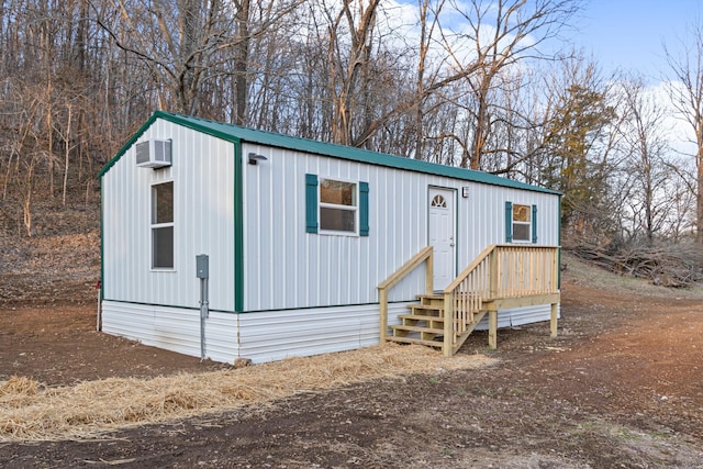 view of front of house with a wall mounted AC