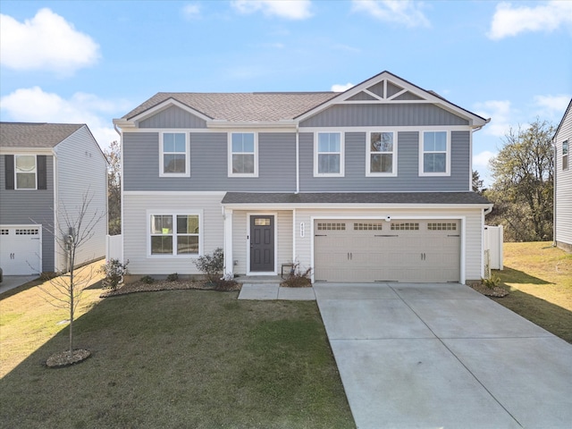 view of front of home featuring a front yard and a garage