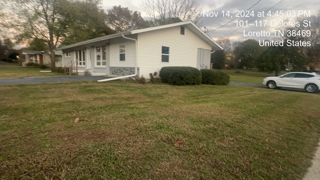 view of side of home featuring a lawn