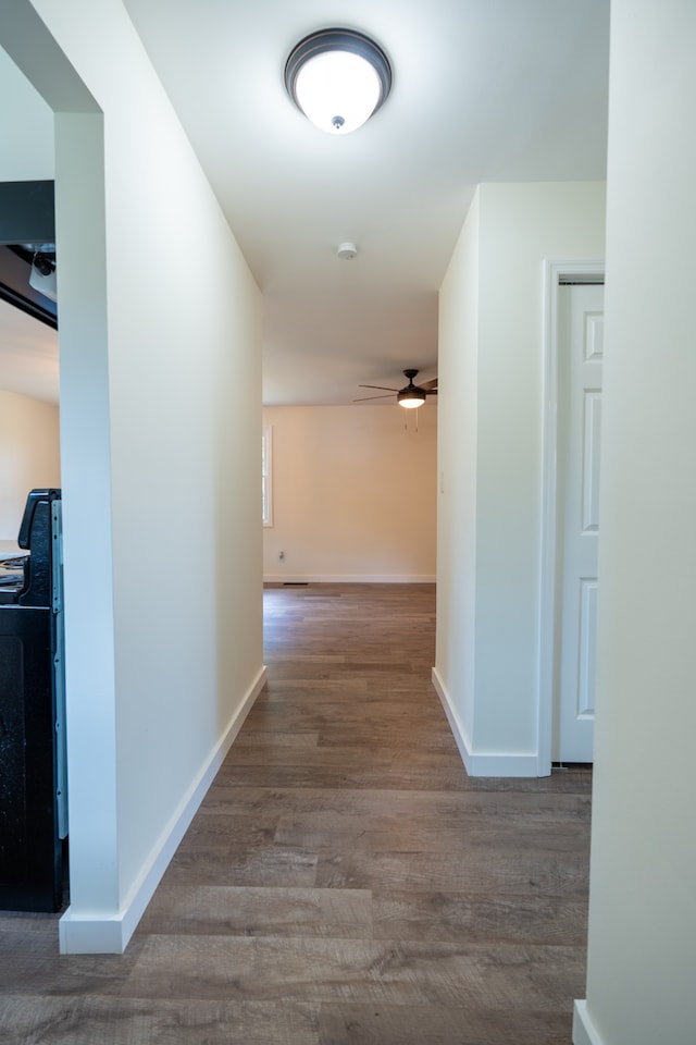 hallway with hardwood / wood-style floors