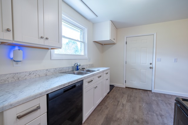 kitchen featuring light stone countertops, white cabinets, sink, wood-type flooring, and dishwasher