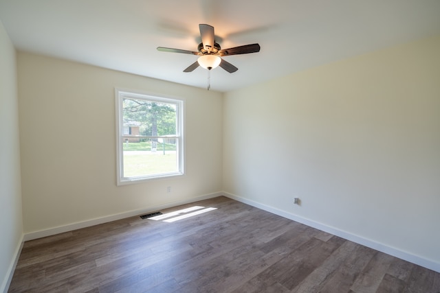 empty room featuring ceiling fan and dark hardwood / wood-style floors