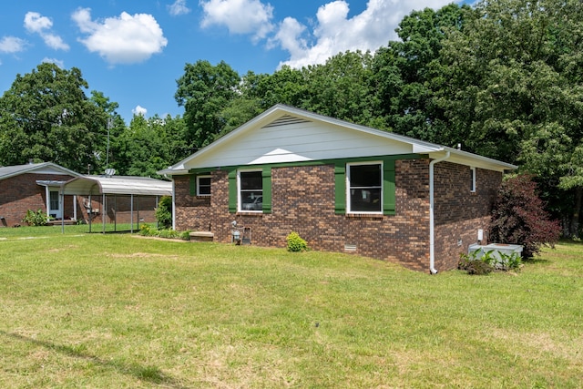 exterior space featuring a front yard and a carport