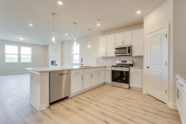 kitchen with white cabinets, a healthy amount of sunlight, sink, and stainless steel appliances