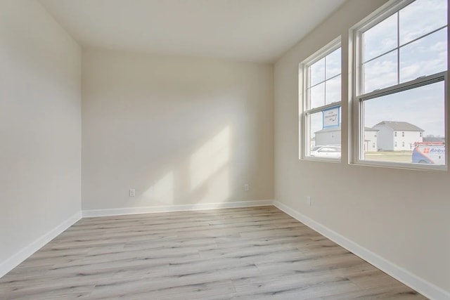 spare room featuring light hardwood / wood-style floors