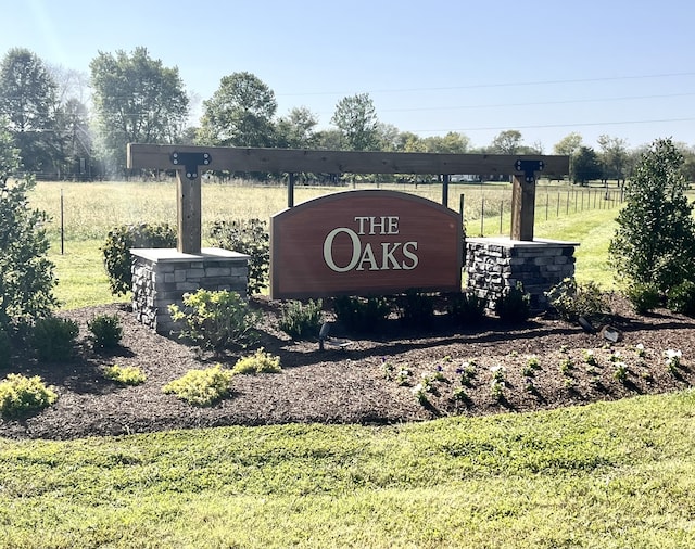 community / neighborhood sign with a rural view