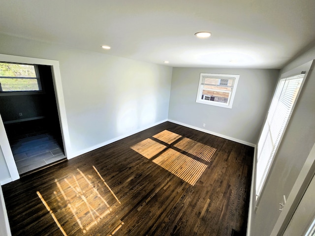 unfurnished room with dark wood-type flooring