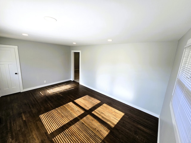 empty room featuring dark wood-type flooring