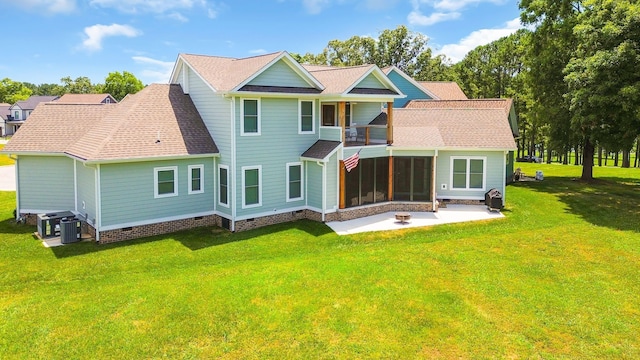 rear view of property with a patio area, a sunroom, a yard, and cooling unit