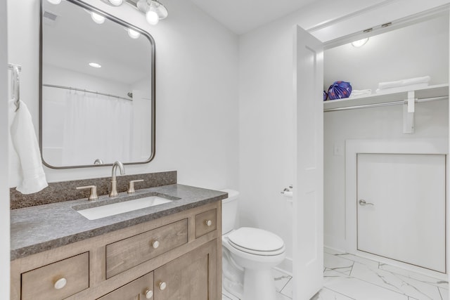 bathroom featuring vanity and toilet