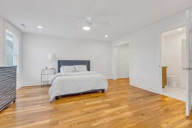 bedroom featuring ensuite bath, ceiling fan, and light hardwood / wood-style flooring