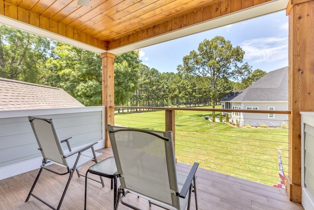 wooden deck with a lawn