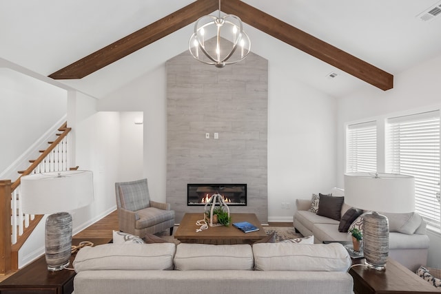 living room with a tile fireplace, wood-type flooring, high vaulted ceiling, an inviting chandelier, and beamed ceiling