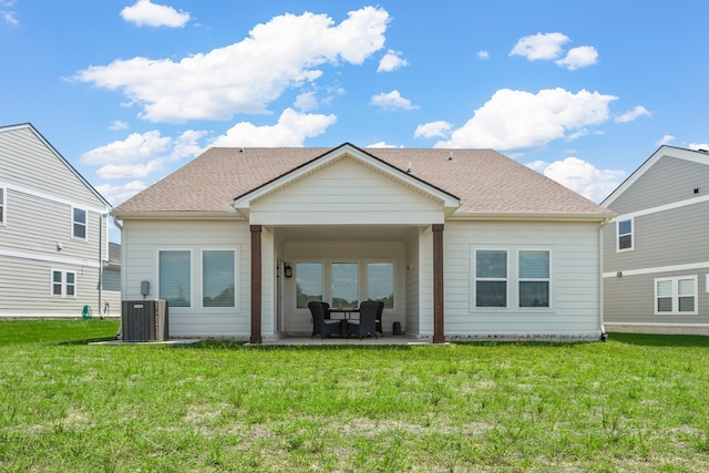 back of house featuring cooling unit, a patio area, and a yard