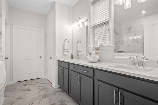 bathroom featuring a tile shower and vanity