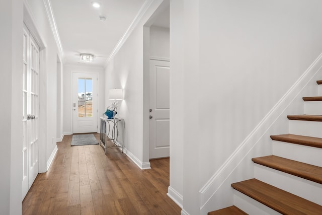 hallway featuring hardwood / wood-style flooring and crown molding