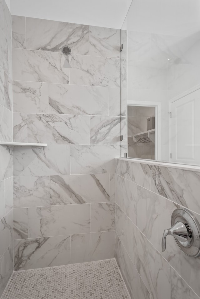 bathroom with tiled shower