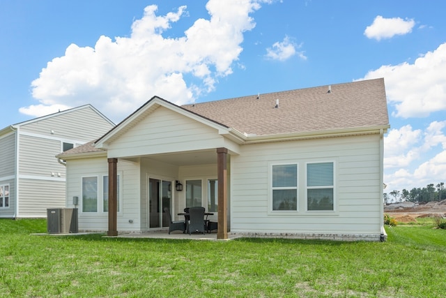 back of house featuring a patio, a lawn, and central air condition unit